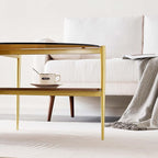 Oval Glass Coffee Table, Mid-Century Modern Design, L43 x W22 x H17 inch, 2-Tier Structure, Olive Shaped Amber Glass Top and Walnut Finish Wood Shelf, Tapered Legs with Gold Finish Frame